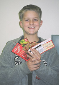 Young volunteer displaying collected grocery store gift cards